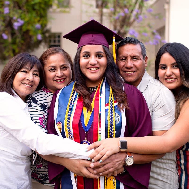 CF Microsite-Bold Ideas-Justice Forward-Circle Student and family embracing at graduation